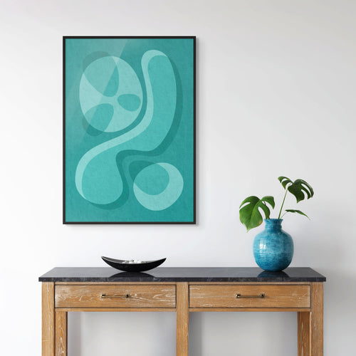 Abstract mid-century art print in a black frame displayed above a wooden console table in a modern living room interior.
