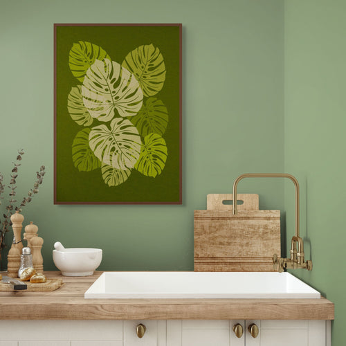 Canopy green botanical wall art hanging in a calm kitchen interior with natural wood and soft green walls