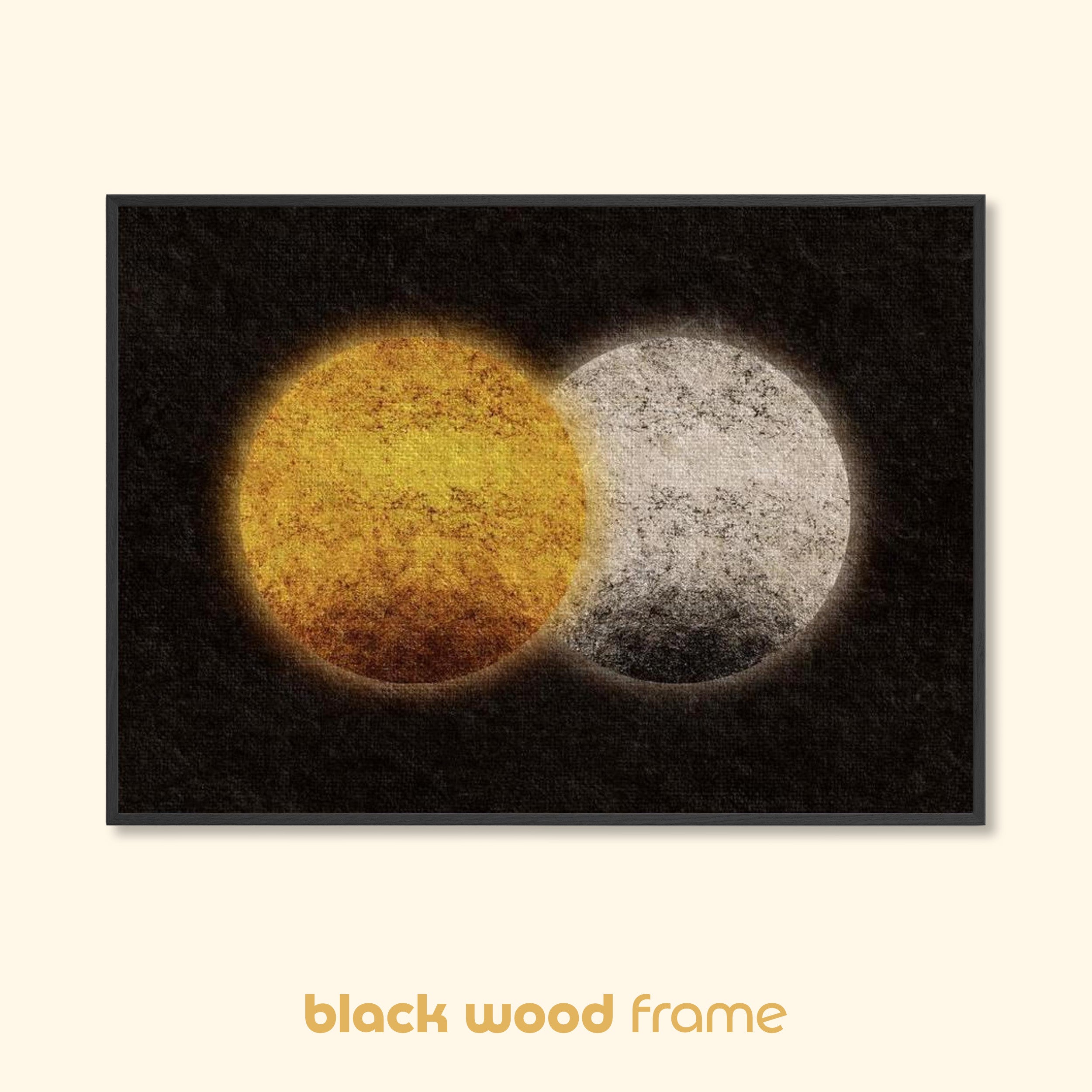 Abstract sun and moon wall art with intersecting golden and pale circular forms on a dark background, presented in a slim black wood frame.