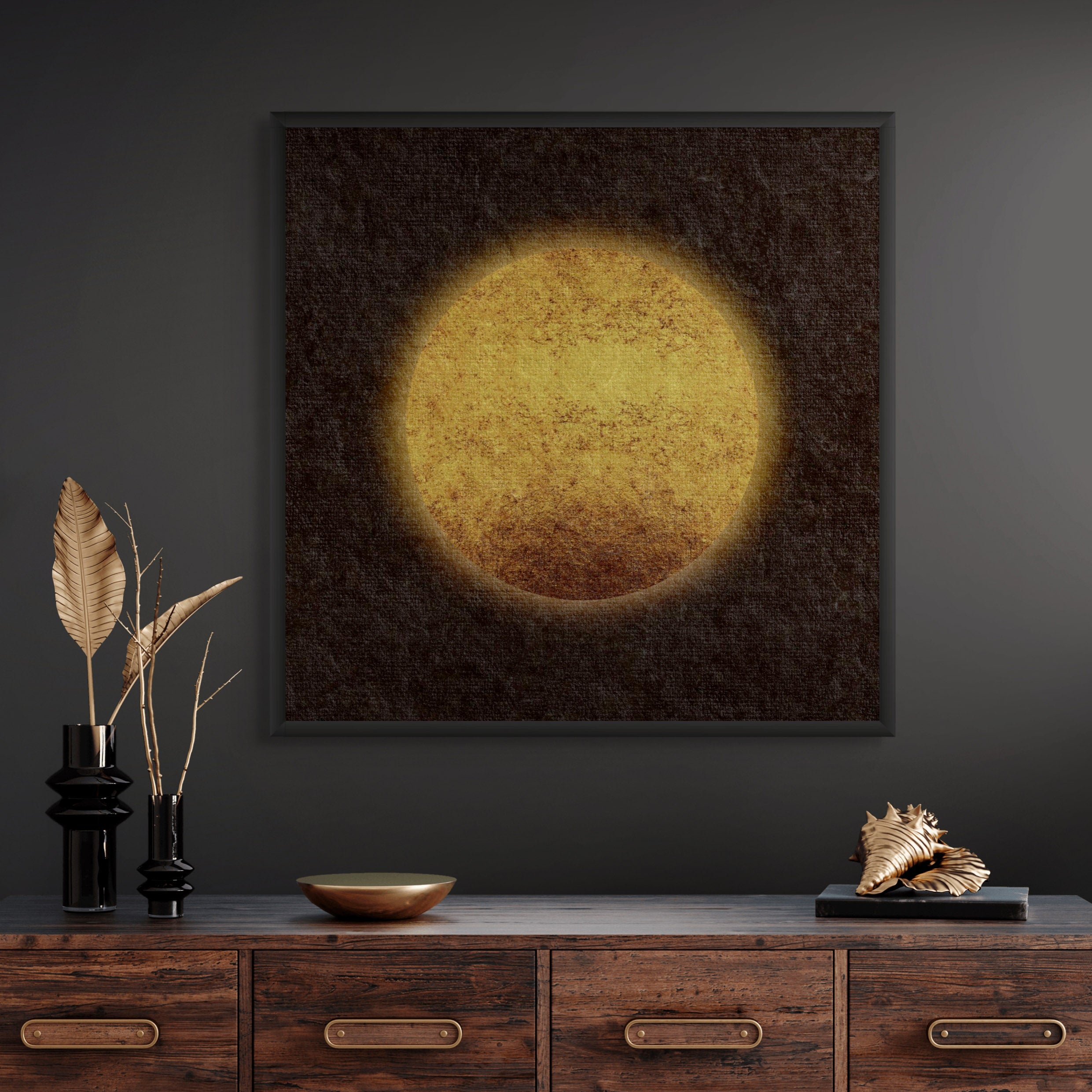 Sun-inspired abstract art print with a warm golden circle displayed in a black frame above a wooden sideboard in a modern interior.