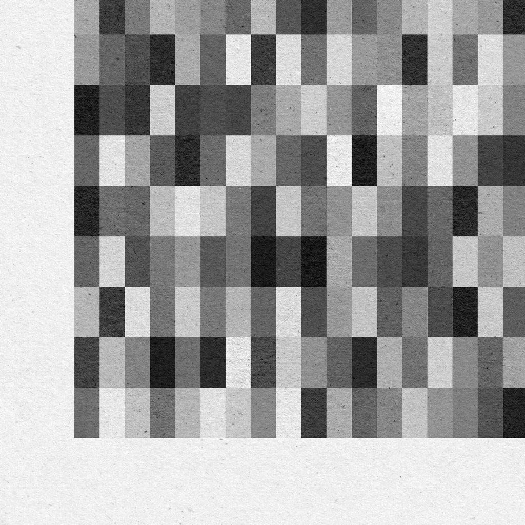 Close-up detail of monochrome geometric abstract print showing tonal variation and printed paper texture.