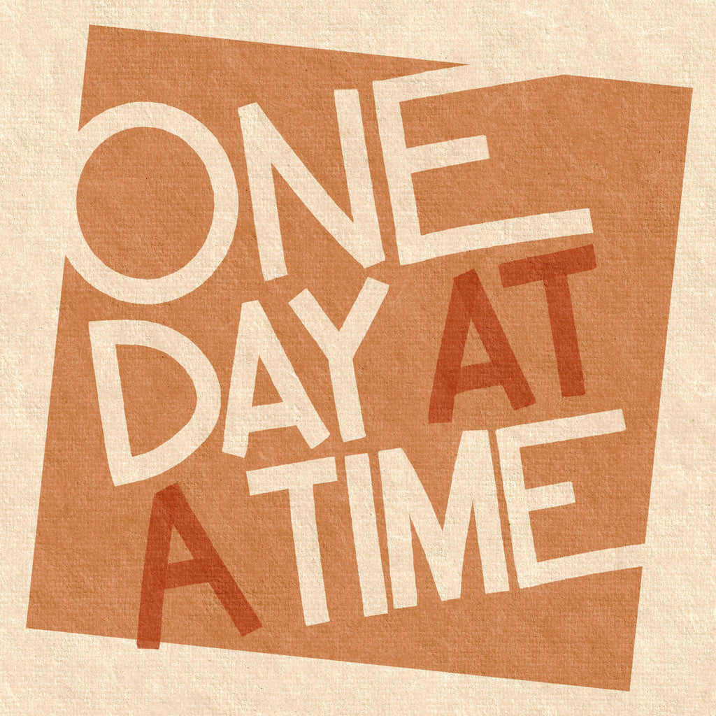 Close-up of One Day at a Time typographic print showing textured paper effect, warm terracotta shapes, and hand-drawn lettering