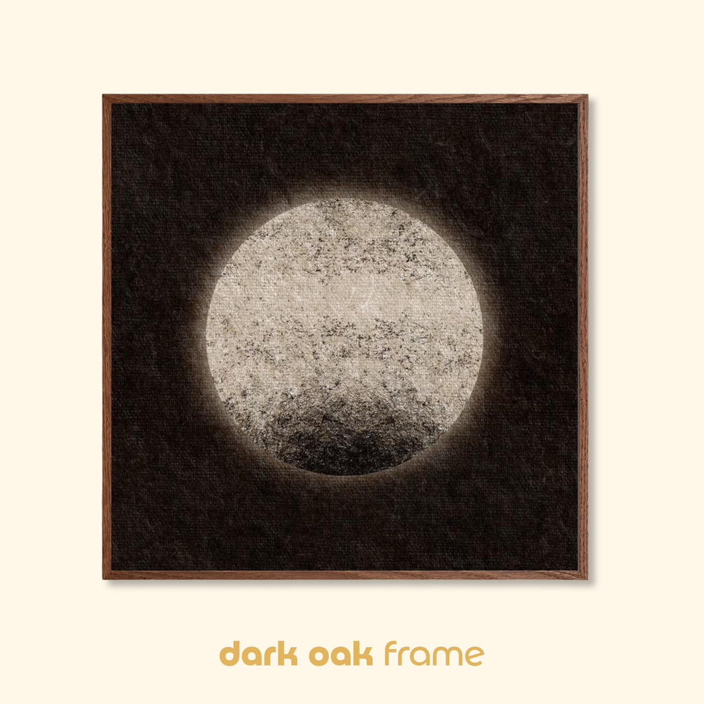 Moon-inspired abstract art print with a pale textured circular form, shown in a dark oak wood frame against a neutral background.