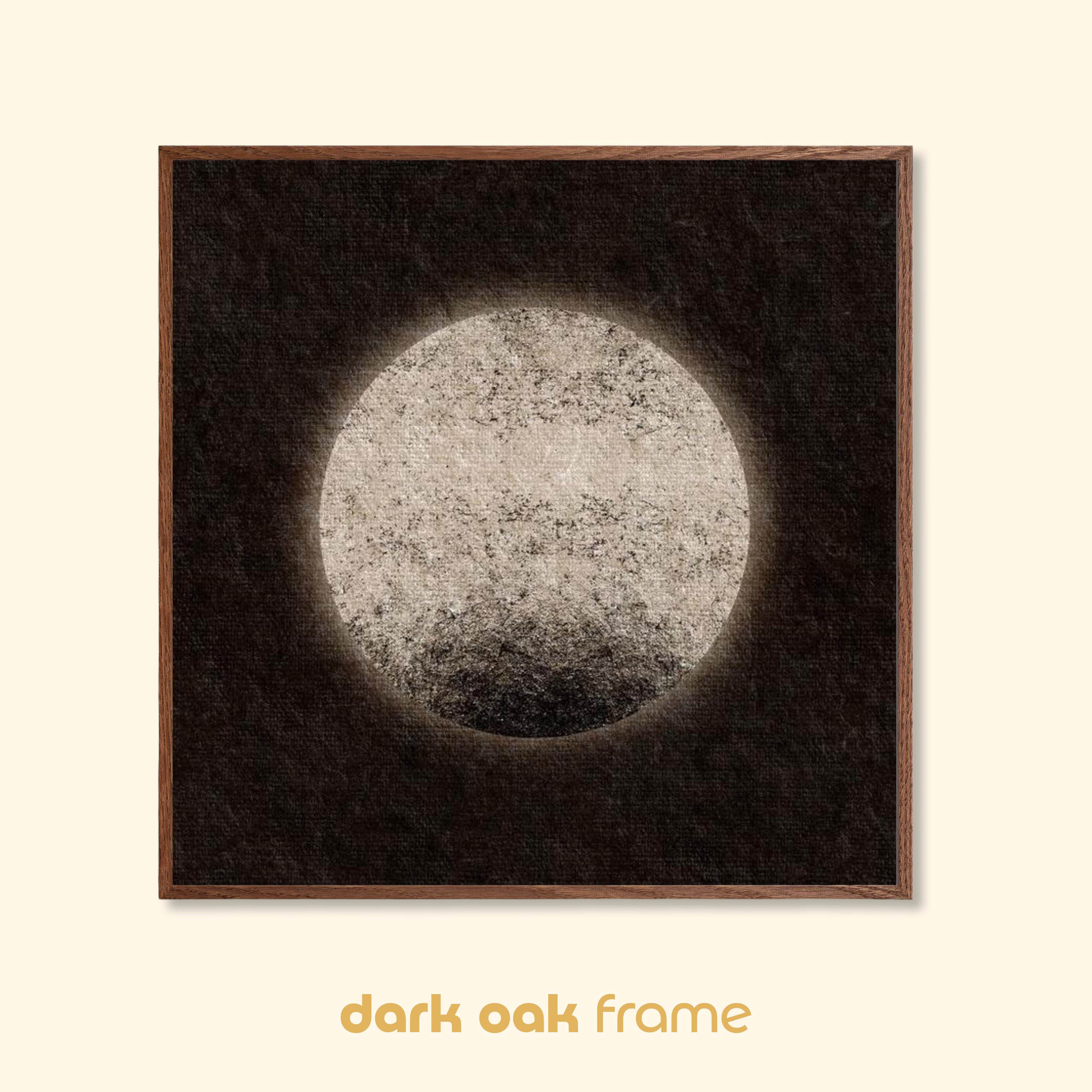 Moon-inspired abstract art print with a pale textured circular form, shown in a dark oak wood frame against a neutral background.