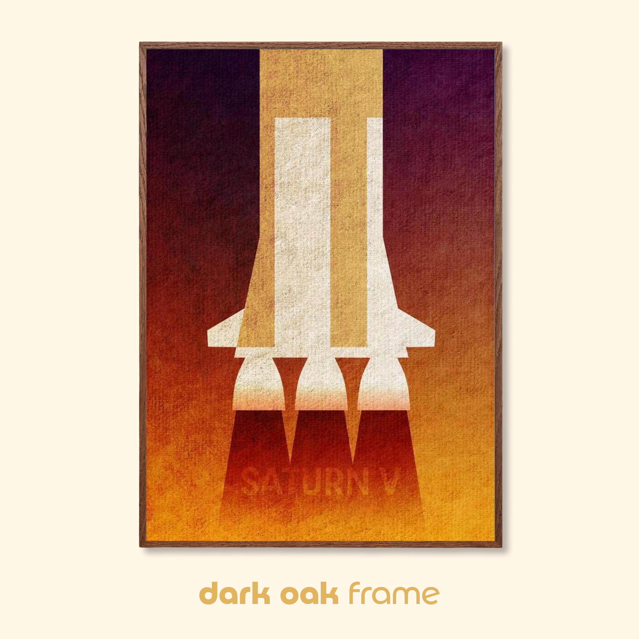Saturn V minimalist rocket art print in a dark oak frame with warm red and gold tones.